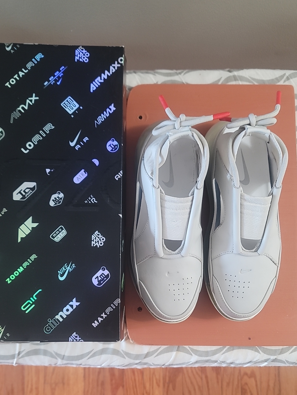 Nike White Slip-On Sneakers with Black Side Stripe and Red Lace Tips